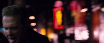 Movie still from “Get Carter” (2000), directed by Stephen Kay – A blurry image of a person standing in front of a neon sign; Close Up shot, Over the shoulder angle