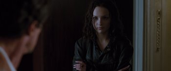 Movie still from “Get Carter” (2000), directed by Stephen Kay – A woman with long dark hair is posing for a picture; Close Up shot, Low angle