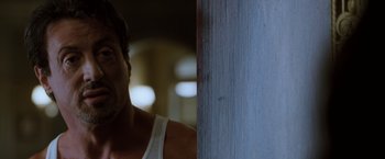 Movie still from “Get Carter” (2000), directed by Stephen Kay – A person leaning against a wall; Close Up shot, Low angle