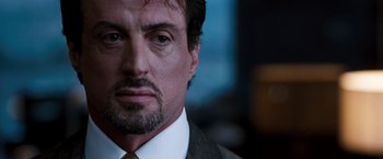 Movie still from “Get Carter” (2000), directed by Stephen Kay – A person wearing a suit and tie; Close Up shot, Over the shoulder angle