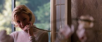 Movie still from “Get Carter” (2000), directed by Stephen Kay – A woman talking on a phone next to a window; Medium shot, Low angle