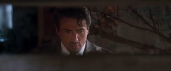 Movie still from “Get Carter” (2000), directed by Stephen Kay – A person wearing a suit and tie; Close Up shot, Over the shoulder angle