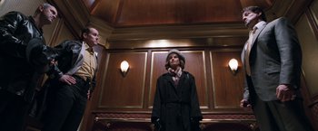 Movie still from “Get Carter” (2000), directed by Stephen Kay – A man and a woman standing next to each other; Medium shot, Low angle