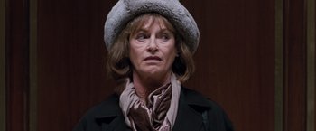 Movie still from “Get Carter” (2000), directed by Stephen Kay – A person wearing a coat and a hat; Close Up shot, Over the shoulder angle