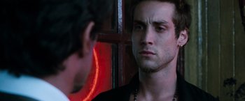 Movie still from “Get Carter” (2000), directed by Stephen Kay – A young man looking into a mirror while standing next to another young man; Close Up shot, Over the shoulder angle