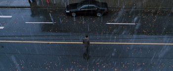 Movie still from “Get Carter” (2000), directed by Stephen Kay – A man standing on the side of a road in the rain; Extreme Wide shot, High angle