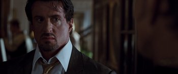 Movie still from “Get Carter” (2000), directed by Stephen Kay – A person wearing a suit and tie; Close Up shot, Low angle