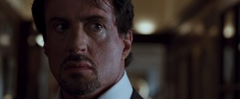 Movie still from “Get Carter” (2000), directed by Stephen Kay – A person wearing a suit and tie; Close Up shot, Over the shoulder angle