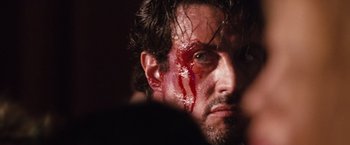Movie still from “Get Carter” (2000), directed by Stephen Kay – A person with blood on his face; Close Up shot, Over the shoulder angle