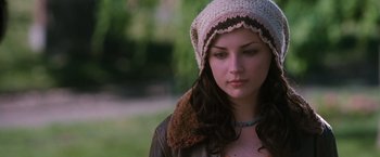Movie still from “Get Carter” (2000), directed by Stephen Kay – A young woman wearing a hat and a brown jacket; Close Up shot, Over the shoulder angle
