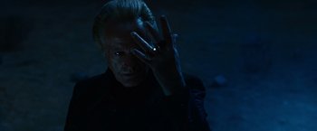 Movie still from “Ghost Rider” (2007), directed by Mark Steven Johnson – A man in a black jacket holding his hand up to his face; Close Up shot, Low angle