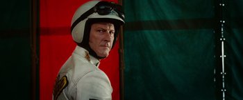 Movie still from “Ghost Rider” (2007), directed by Mark Steven Johnson – A man wearing a white motorcycle jacket and a helmet; Close Up shot, Low angle