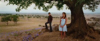 Movie still from “Ghost Rider” (2007), directed by Mark Steven Johnson – A man and a woman standing next to a tree; Wide shot, Over the shoulder angle