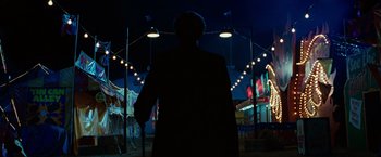 Movie still from “Ghost Rider” (2007), directed by Mark Steven Johnson – A man standing in front of an amusement ride; Wide shot, Low angle