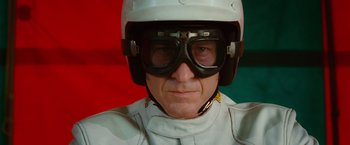 Movie still from “Ghost Rider” (2007), directed by Mark Steven Johnson – A man wearing a helmet , goggles , and a white uniform; Close Up shot, Low angle