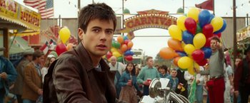 Movie still from “Ghost Rider” (2007), directed by Mark Steven Johnson – A man in a brown leather jacket at an amusement park; Close Up shot, Over the shoulder angle