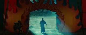 Movie still from “Ghost Rider” (2007), directed by Mark Steven Johnson – A man standing in front of a fire tunnel; Extreme Wide shot, High angle