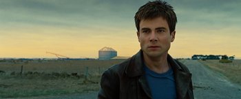 Movie still from “Ghost Rider” (2007), directed by Mark Steven Johnson – A person wearing a jacket near a field; Close Up shot, Over the shoulder angle