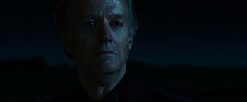 Movie still from “Ghost Rider” (2007), directed by Mark Steven Johnson – An older man in a black shirt is looking at the camera; Close Up shot, Low angle