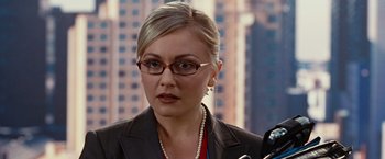 Movie still from “Ghost Rider” (2007), directed by Mark Steven Johnson – A person wearing a suit and glasses; Close Up shot, Over the shoulder angle