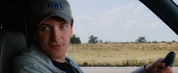 Movie still from “Ghost Rider” (2007), directed by Mark Steven Johnson – A person wearing a hat near a field; Close Up shot, Over the shoulder angle