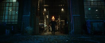 Movie still from “Ghost Rider” (2007), directed by Mark Steven Johnson – A man with a fire in his mouth walking through a building; Wide shot, Low angle