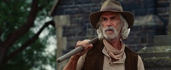 Movie still from “Ghost Rider” (2007), directed by Mark Steven Johnson – An old man with a hat holding a wooden stick; Close Up shot, Low angle