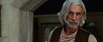 Movie still from “Ghost Rider” (2007), directed by Mark Steven Johnson – An older man with long white hair and a beard; Close Up shot, Over the shoulder angle