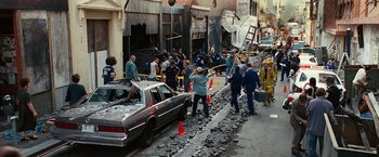 Movie still from “Ghost Rider” (2007), directed by Mark Steven Johnson – A group of people standing next to a car on a street; Wide shot, High angle