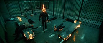 Movie still from “Ghost Rider” (2007), directed by Mark Steven Johnson – A man that is standing in front of some people; Wide shot, Overhead angle