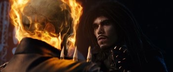 Movie still from “Ghost Rider” (2007), directed by Mark Steven Johnson – A person with a skull on fire; Close Up shot, Over the shoulder angle