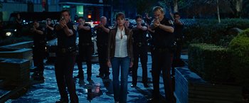 Movie still from “Ghost Rider” (2007), directed by Mark Steven Johnson – A group of people standing in front of a group of police officers; Wide shot, Over the shoulder angle