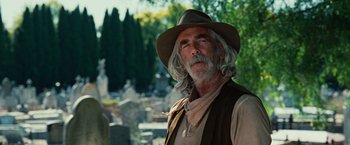 Movie still from “Ghost Rider” (2007), directed by Mark Steven Johnson – An older man with a long beard wearing a cowboy hat; Medium shot, Low angle