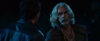 Movie still from “Ghost Rider” (2007), directed by Mark Steven Johnson – A man with long white hair talking to another man; Close Up shot, Over the shoulder angle
