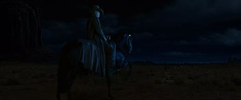 Movie still from “Ghost Rider” (2007), directed by Mark Steven Johnson – A man riding a horse in the dark at night; Wide shot, Low angle