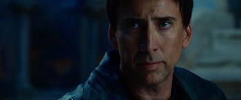 Movie still from “Ghost Rider” (2007), directed by Mark Steven Johnson – A man's face in a dark room; Close Up shot, Over the shoulder angle
