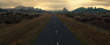 Movie still from “Ghost Rider” (2007), directed by Mark Steven Johnson – An empty road in the middle of a desert landscape; Extreme Wide shot, High angle