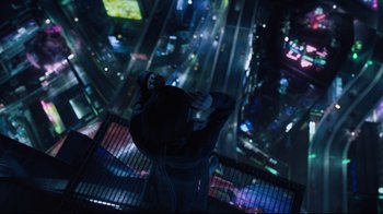Movie still from “Ghost in the Shell” (2017), directed by Rupert Sanders – A man standing on a building looking down at a city; Wide shot, Overhead angle