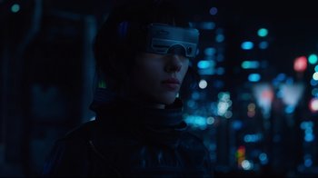Movie still from “Ghost in the Shell” (2017), directed by Rupert Sanders – A woman wearing goggles and a leather jacket in the dark; Close Up shot, Over the shoulder angle