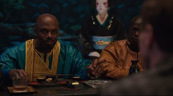 Movie still from “Ghost in the Shell” (2017), directed by Rupert Sanders – Two men sitting at a table with chopsticks in their hands; Medium shot, Over the shoulder angle