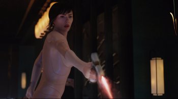 Movie still from “Ghost in the Shell” (2017), directed by Rupert Sanders – A woman is holding a light saber in her hand; Medium shot, Low angle