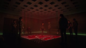 Movie still from “Ghost in the Shell” (2017), directed by Rupert Sanders – A group of people standing in a room with lights on; Extreme Wide shot, High angle