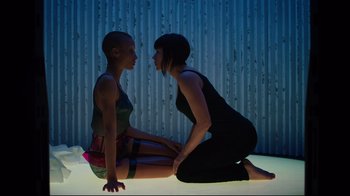 Movie still from “Ghost in the Shell” (2017), directed by Rupert Sanders – Two women sitting on the ground in front of one another; Medium shot, Overhead angle