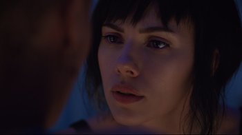 Movie still from “Ghost in the Shell” (2017), directed by Rupert Sanders – A woman's face in the dark; Close Up shot, Over the shoulder angle
