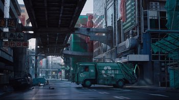 Movie still from “Ghost in the Shell” (2017), directed by Rupert Sanders – A garbage truck parked on the side of the street; Extreme Wide shot, High angle