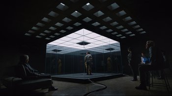 Movie still from “Ghost in the Shell” (2017), directed by Rupert Sanders – Two people standing in front of a mirror in a dark room; Extreme Wide shot, Low angle