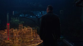 Movie still from “Ghost in the Shell” (2017), directed by Rupert Sanders – A man standing in front of a city at night; Wide shot, High angle