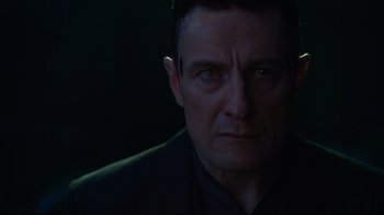 Movie still from “Ghost in the Shell” (2017), directed by Rupert Sanders – A person wearing a suit and tie; Close Up shot, Low angle
