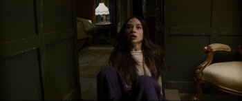 A woman sitting on the ground in a room