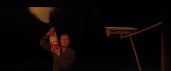 Movie still from “Three Billboards Outside Ebbing, Missouri” (2017), directed by Martin McDonagh – A woman holding a fire extinguisher in her hands; Medium shot, Low angle
